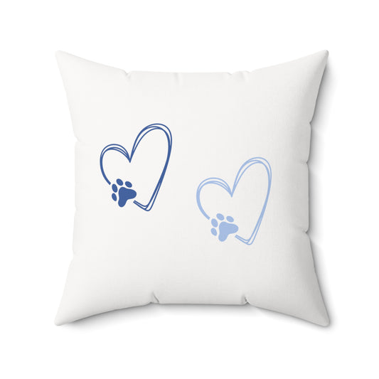 White throw pillow with two heart-shaped paw prints in light and navy blue
