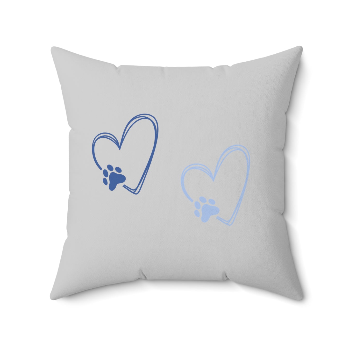 Light gray pillow with blue paw heart illustrations on soft neutral background