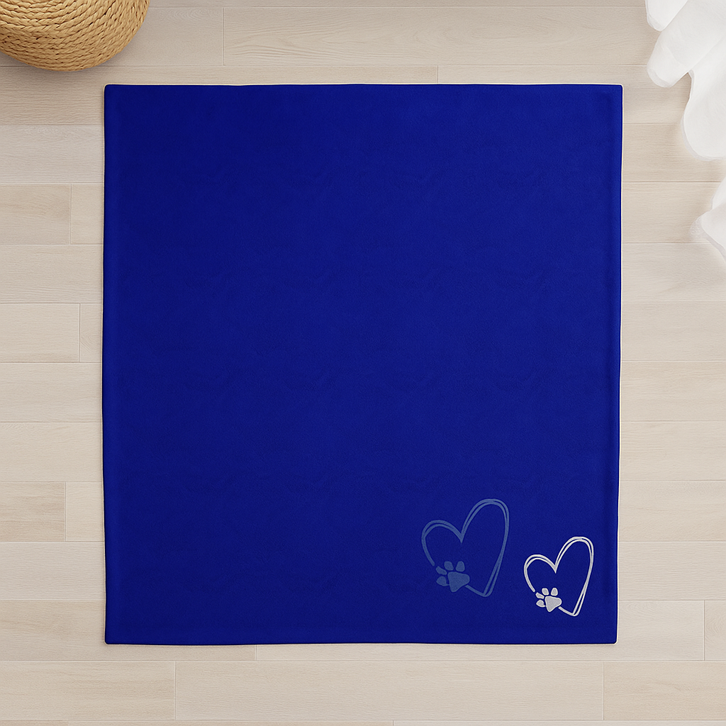 A dark blue velveteen blanket featuring light heart and paw print illustrations,