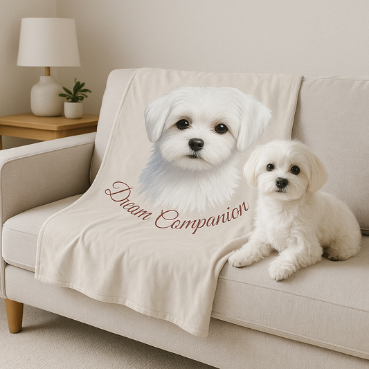 Maltese dog lying on a Dream Companion velveteen blanket on a beige couch