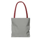 Plain dusty grey tote bag with red handles, no design
