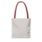 Plain white tote bag with red handles, angled front view