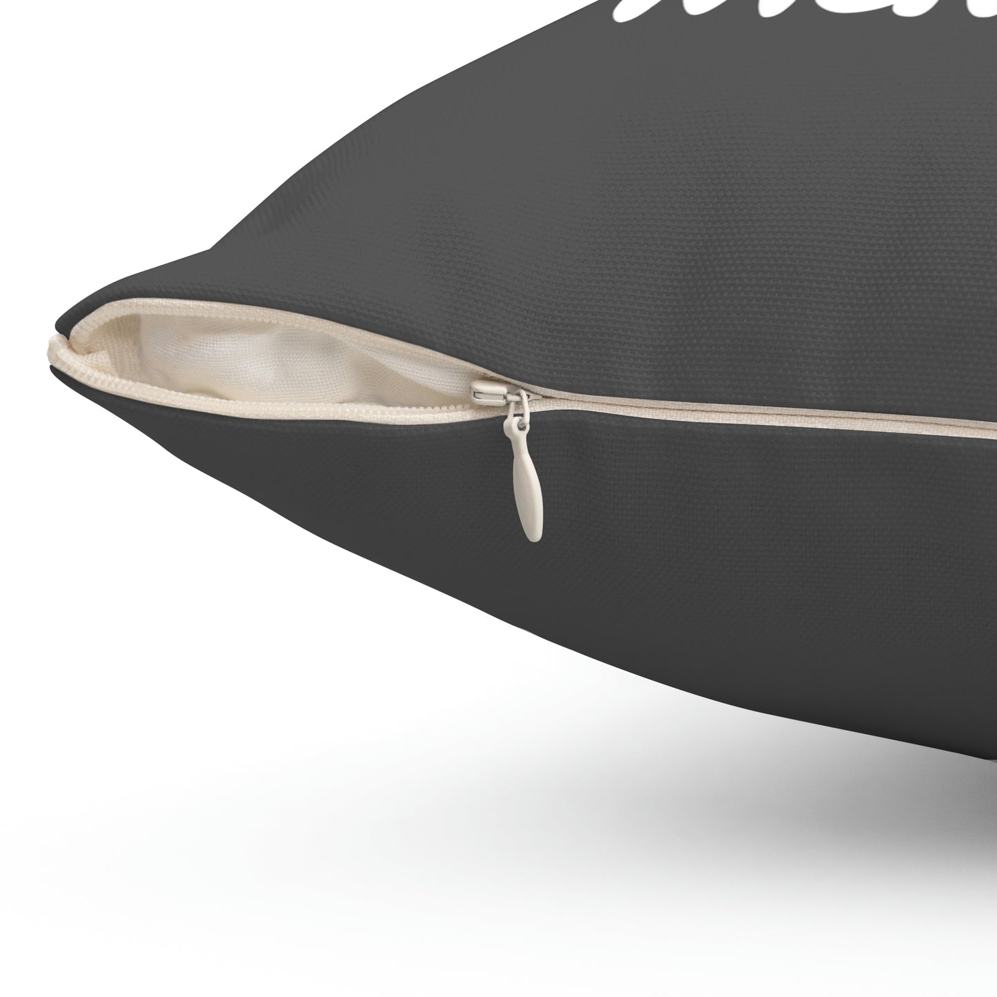 Close-up of concealed zipper on grey quote pillow showing cream-colored insert