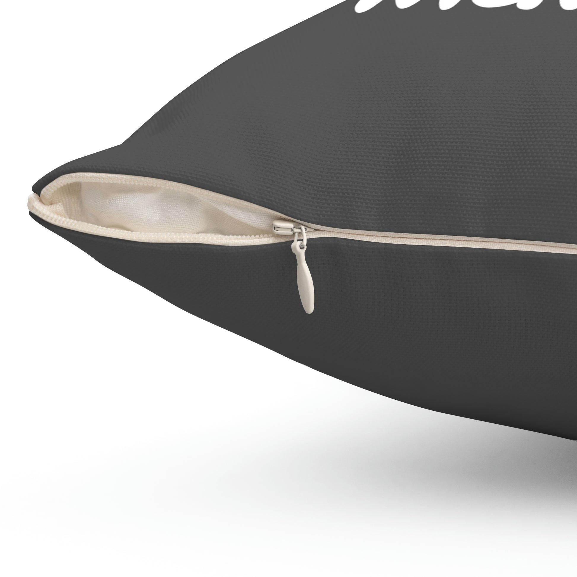 Close-up of concealed zipper on grey quote pillow showing cream-colored insert